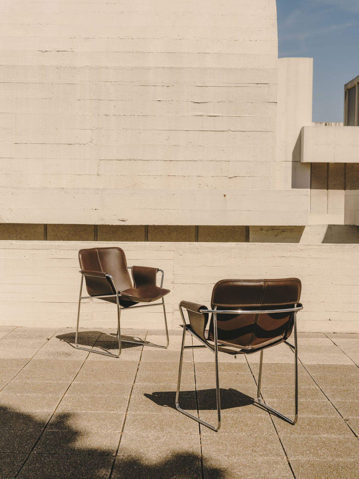 Two Orma armchairs on a terrace