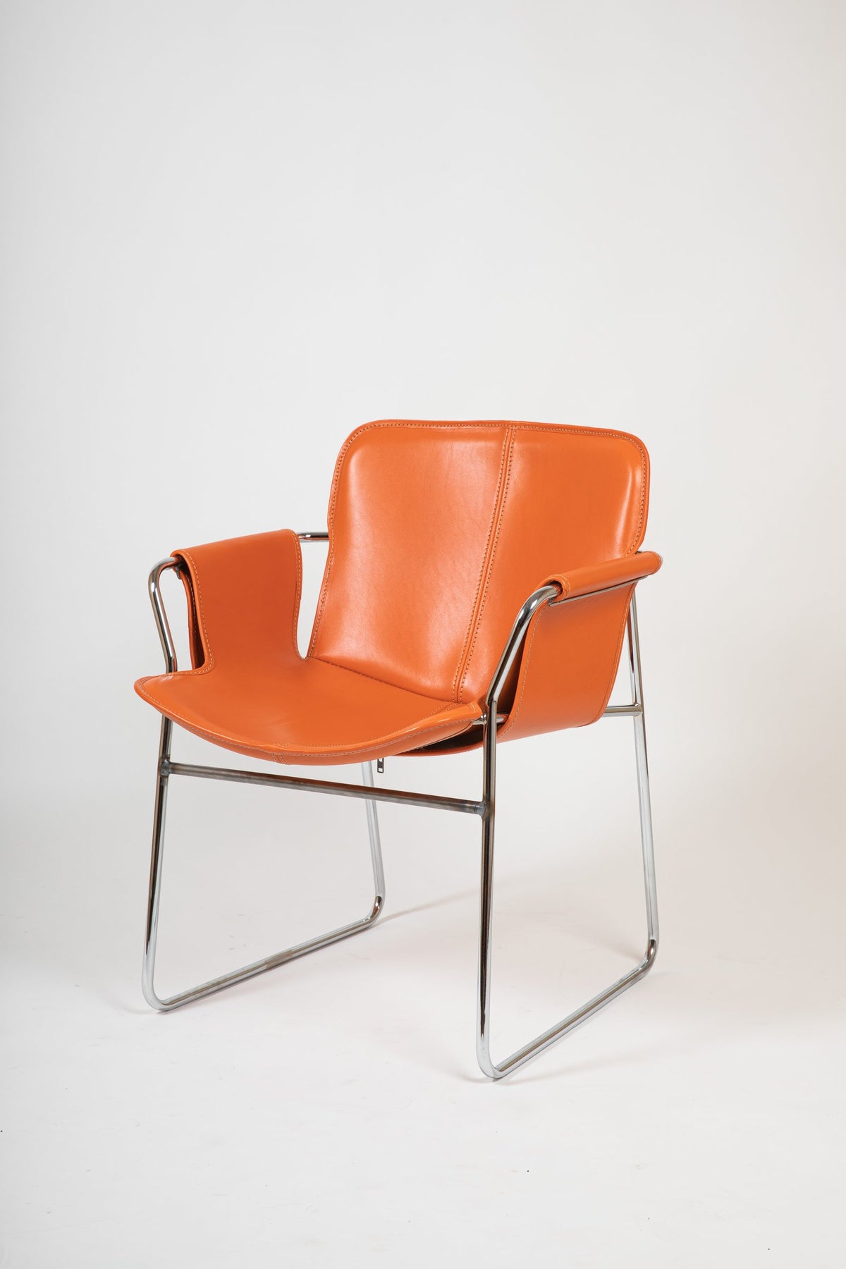 Orma armchair in orange leather, three-quarter view