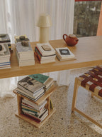 Delta holding books beside a desk