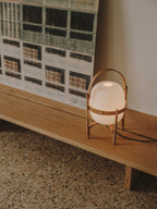 Cestita lamp on a low wooden bench