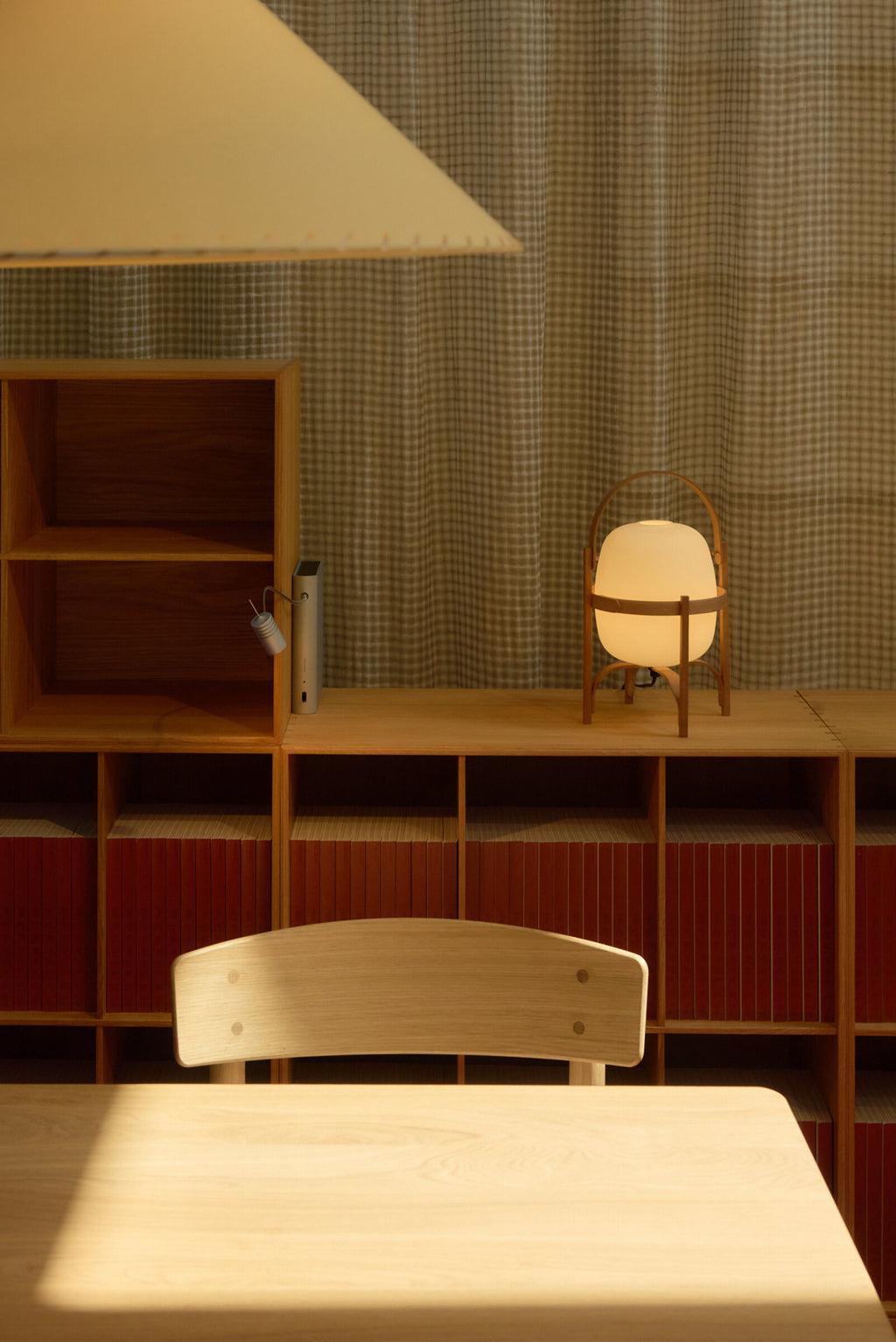 Cestita lamp on a wooden sideboard above a dining table