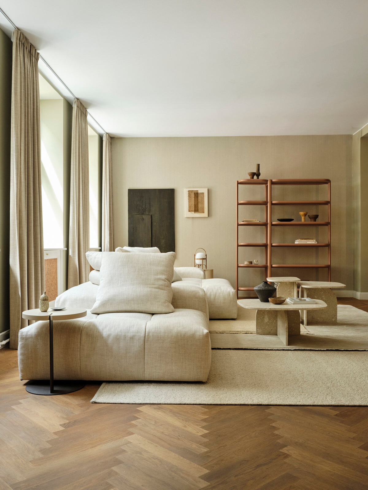 Cestita lamp in a living room with a linen sofa and herringbone floor