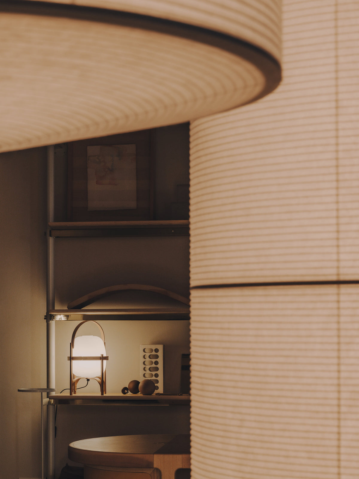 Cestita lamp on a shelf behind a curved wall