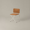 Ramón chair by Ramón Bigas for Santa & Cole with a white metal frame and natural synthetic rattan seat and back