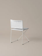 Three-quarter view of the Ramón chair in white rattan