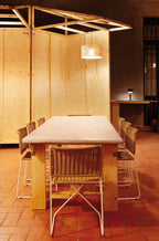 Ramón chairs in natural rattan around a long wooden table