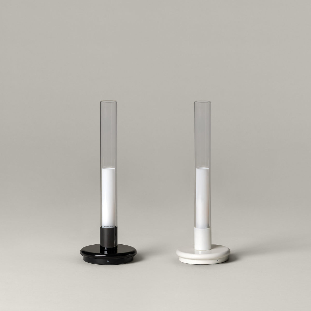 Black and white Sylvestrina portable lamps side by side, switched off