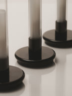 Close view of the rounded black bases of three Sylvestrina lamps