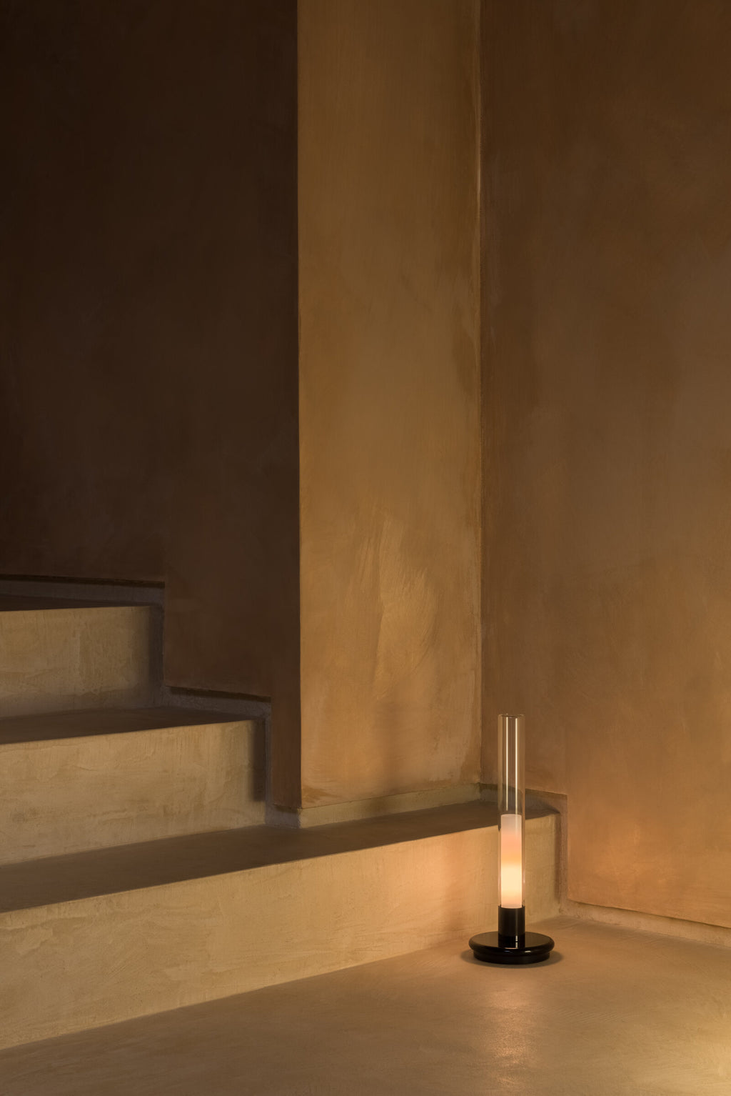 Sylvestrina portable lamp on the floor at the foot of a staircase
